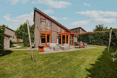 Vakantiehuis met loungeset en vuurkorf in de tuin op Dutchen Park Buiten Bergen